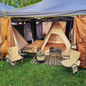 Luxury festival tent setup with cozy beds, camp chairs, and gear from Best in Tents.