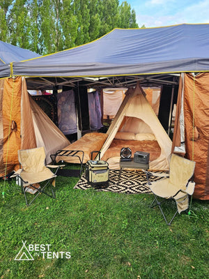 Luxury festival tent setup with cozy beds, camp chairs, and gear from Best in Tents.